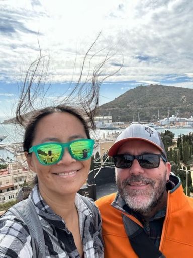 Selfie of Dog and Dragon in the sun and wind of the Mediterranean with Dragon's hair flying upwards in the wind.