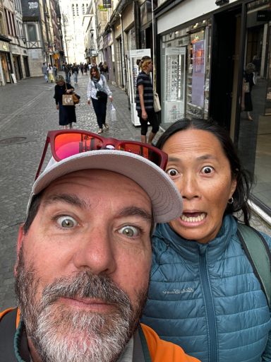 Goofy selfie of bug-eyed Dog and Dragon walking the streets of France.