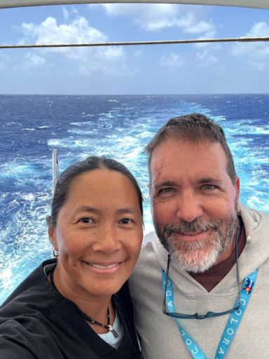 Selfie of Dog and Dragon at the back of the ship with the ocean behind them.