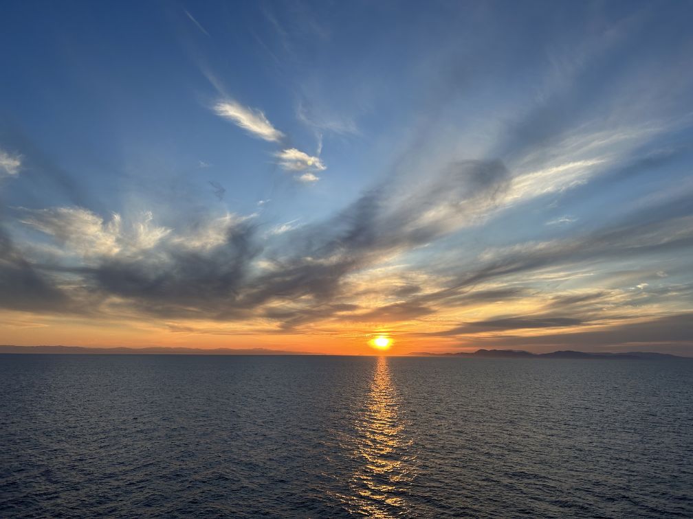 Picture of a Mediterranean sunset over the sea taken from aboard a ship.