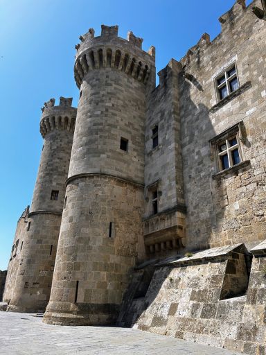 Picture from the ground up of two of the stone towers of the Palace of the Grand Master of the Knights of St. John in the city of Rhodes on the island of Rhodes.