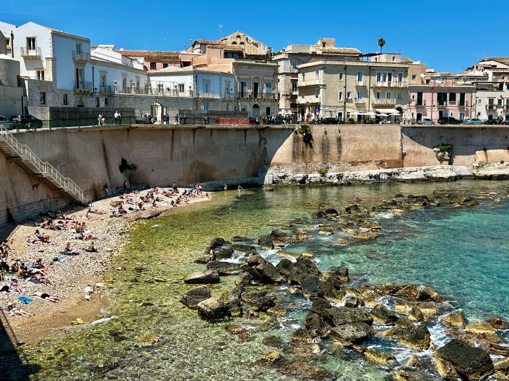 Picture of a beach below the sea wall in Syracuse, Sicily