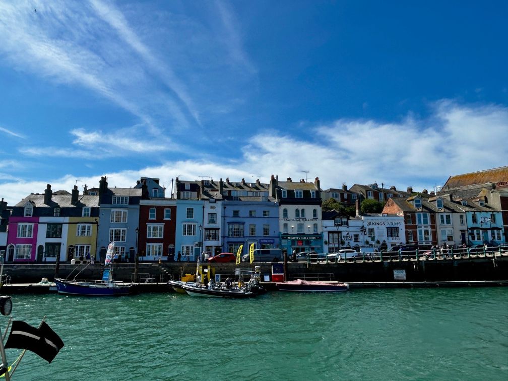 Horizontal picture of colorful row houses along a canal in Weymouth.